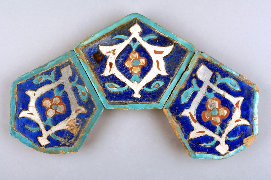 Three tiles with four petalled flowers