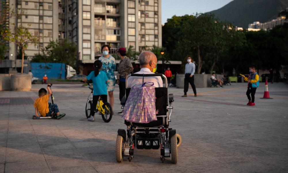 Elderly man in wheelchair in the street