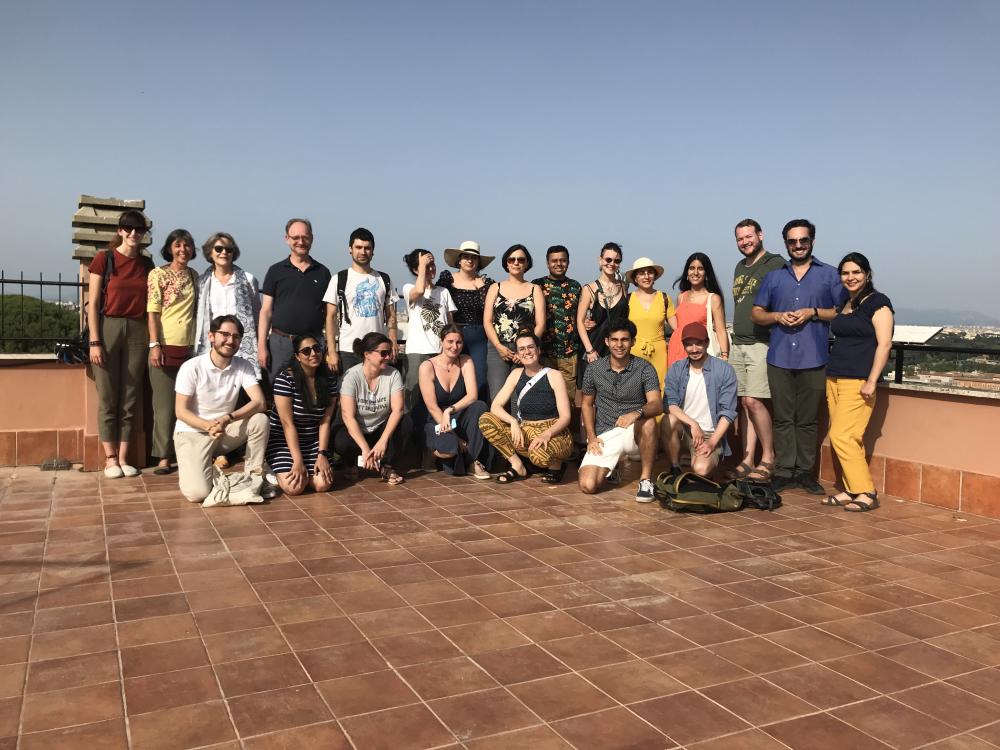 Students and lecturers posed for a group photo on a roof terrace.