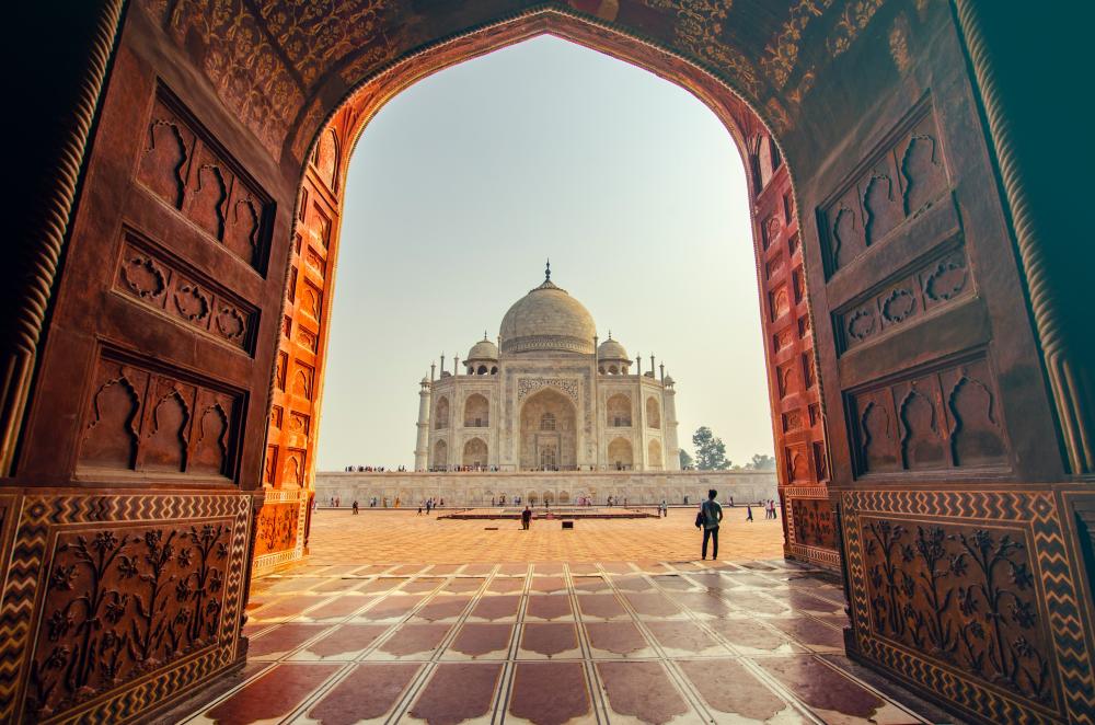 The view of the Taj Mahal through a red arch