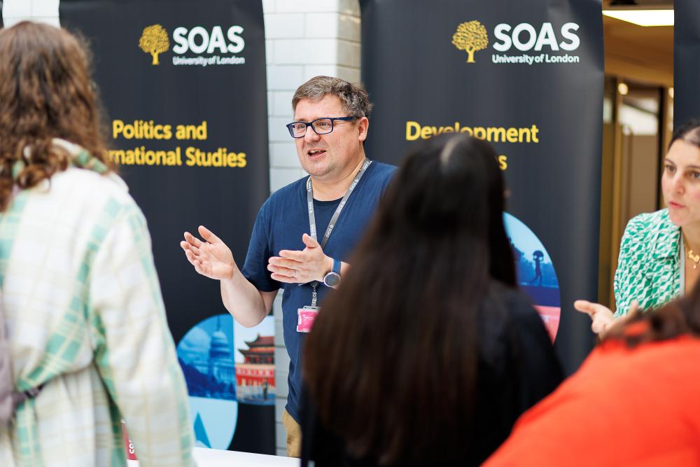 Lecturer talking to a student on open day 