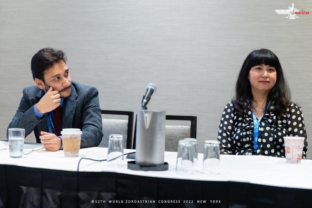 Ruzbeh Hodiwala and Nazneen Engineer sat at a table during a talk at the World Zoroastrian Congress.