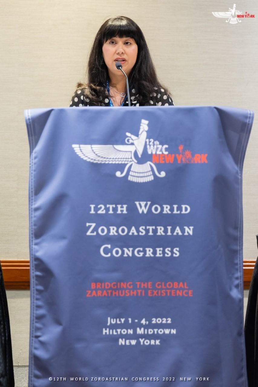 Nazneen Engineer stood behind a lectern while presenting at the World Zoroastrian Congress 
