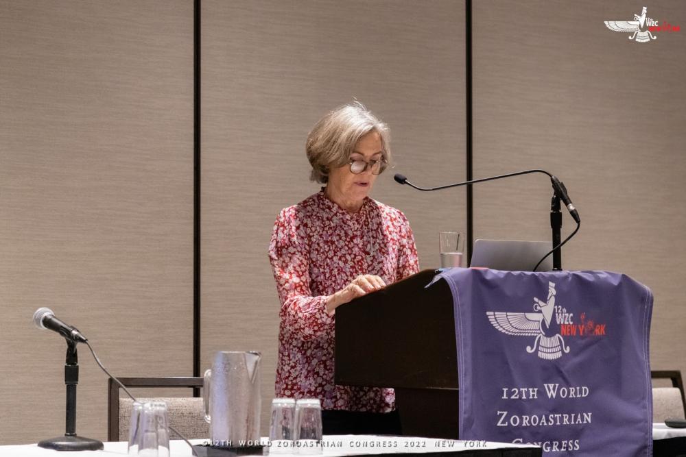 Sarah Stewart stood behind a lectern while presenting at the World Zoroastrian Congress