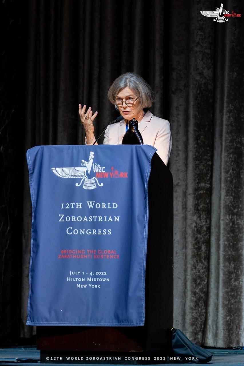 Sarah Stewart stood behind a lectern while presenting at the World Zoroastrian Congress