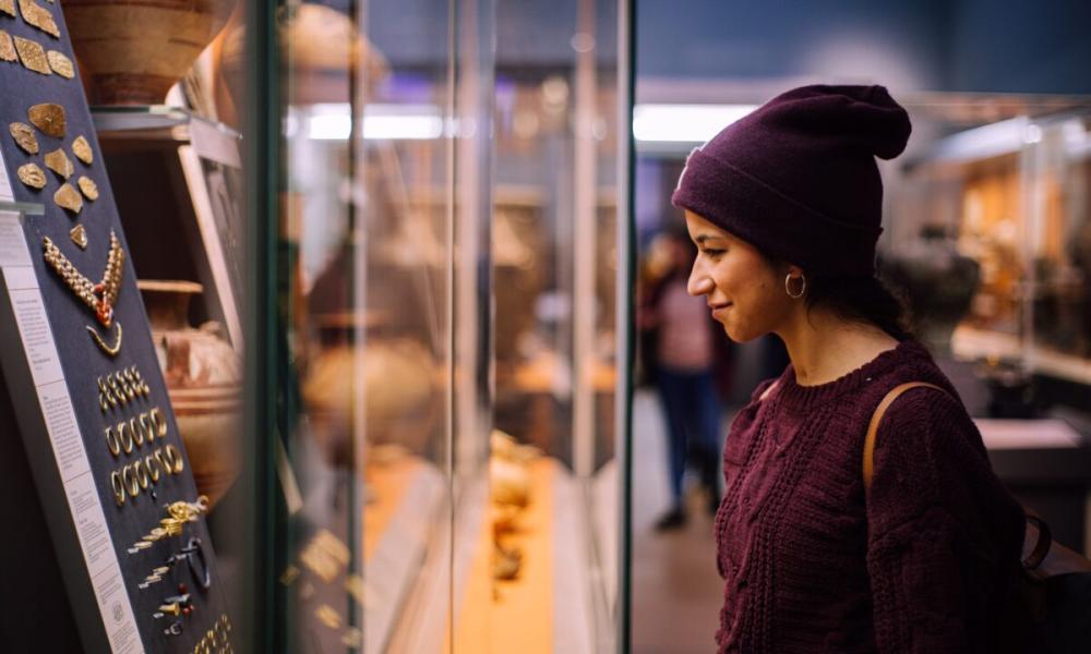 Woman looking at artefacts in a museum