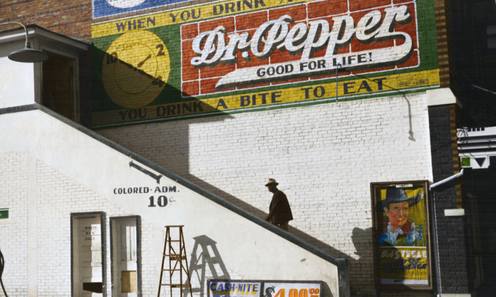 A Black man walks up stairs, during time of segregation in the USA