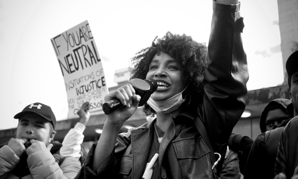 Young person speaking into microphone at a Black Lives Matter protest