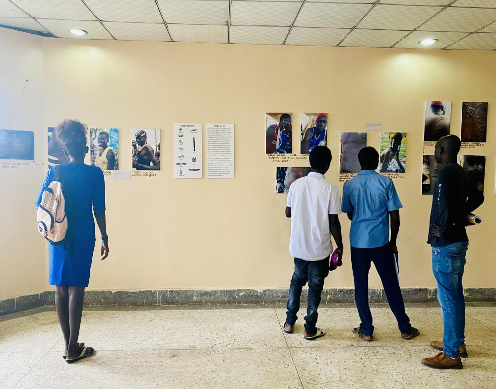 Visitors to the photo exhibit at the University of Juba contemplate and discuss the photos