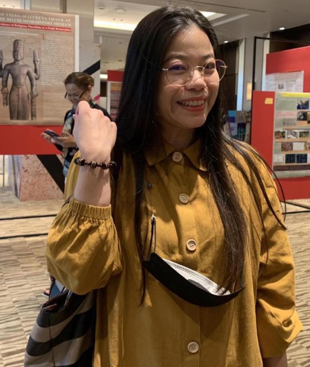 Figure 7. Theint Theint Aung with 'Laksharas' stall and Udomluck Hoontrakul wearing new bracelet (Photo Pwint Phu Maung, Alumni)