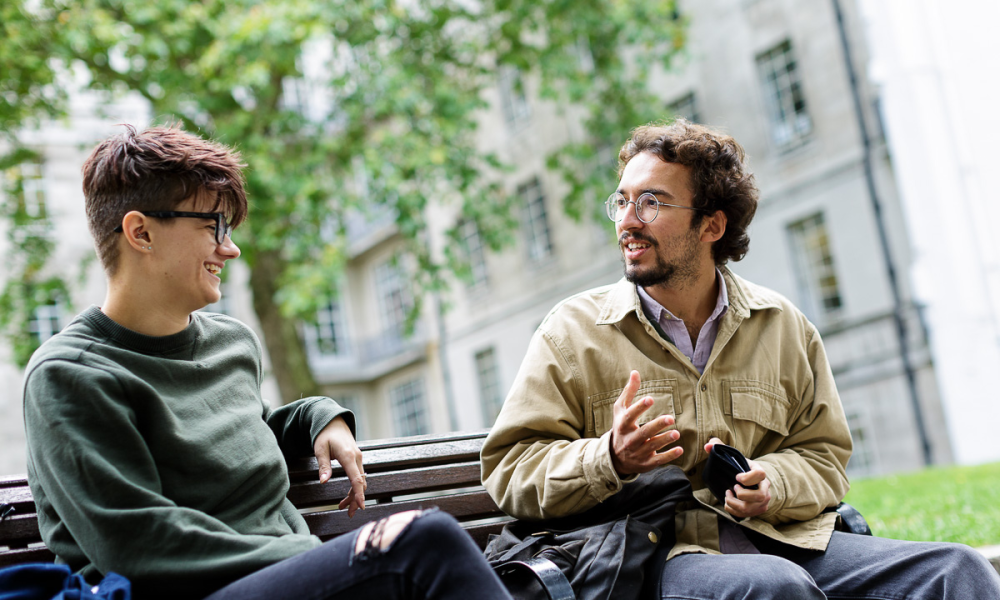 Two students talking outside on campus