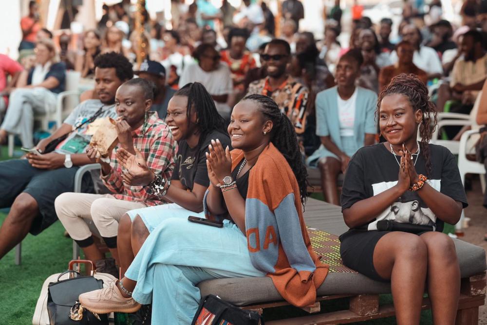 A crowd of people sitting watching a film