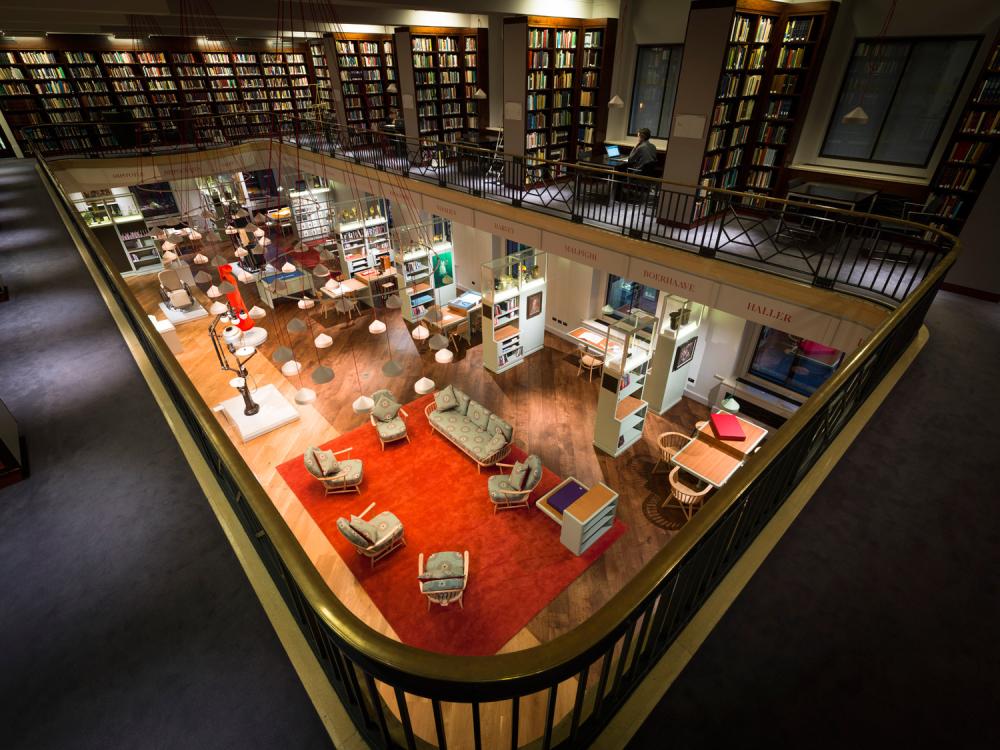 A second floor library with a central atrium looking onto a reading room