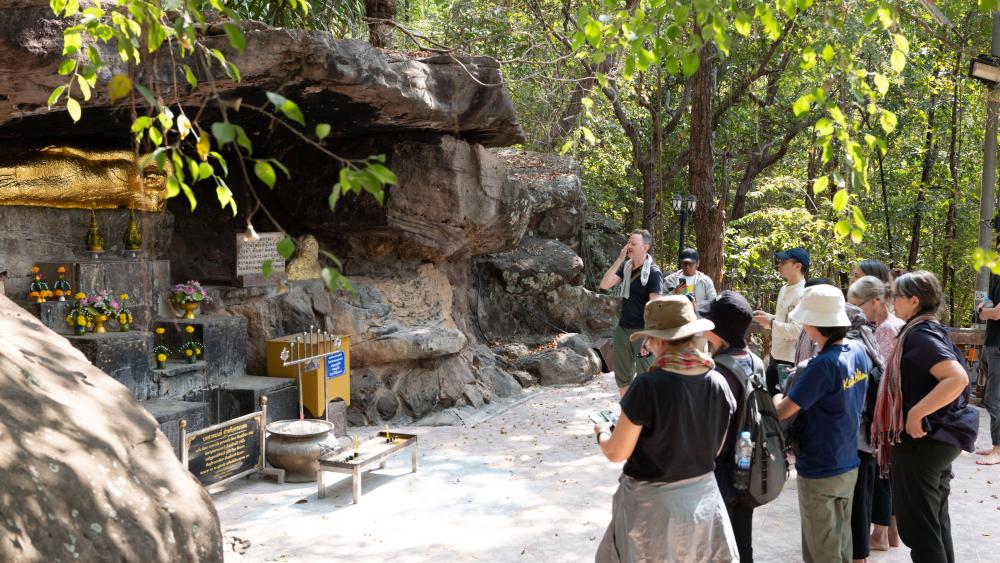 The group in front of the reclining Buddha at Wat Phu Khao. (Photo by Kanat Naktanomsub, courtesy of Getty)