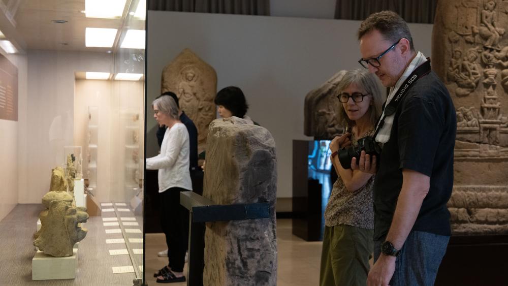 Touring the collection at the Khon Kaen National Museum. (Photo by Kanat Naktanomsub, courtesy of Getty)