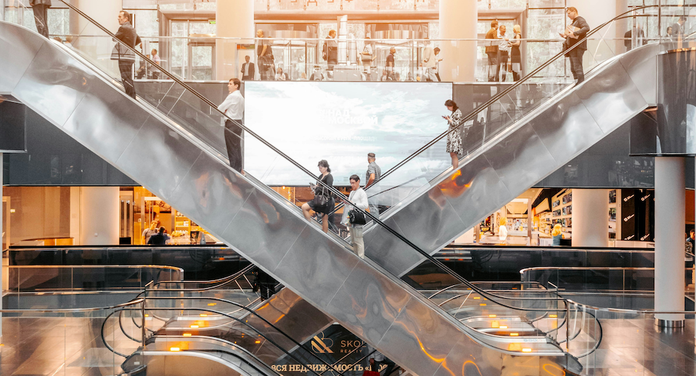 People on escalators in a shopping mall 