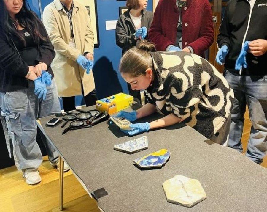 photo ofstudents engaging in object handling workshop in the SOAS Gallery