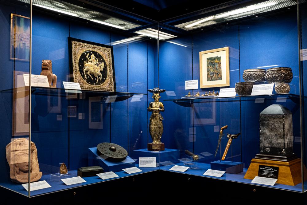 display cases with South East Asian objects inside