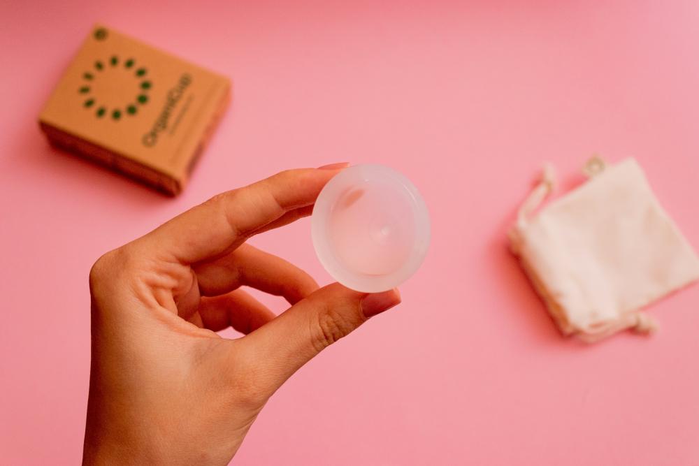 A person holds a menstrual cup
