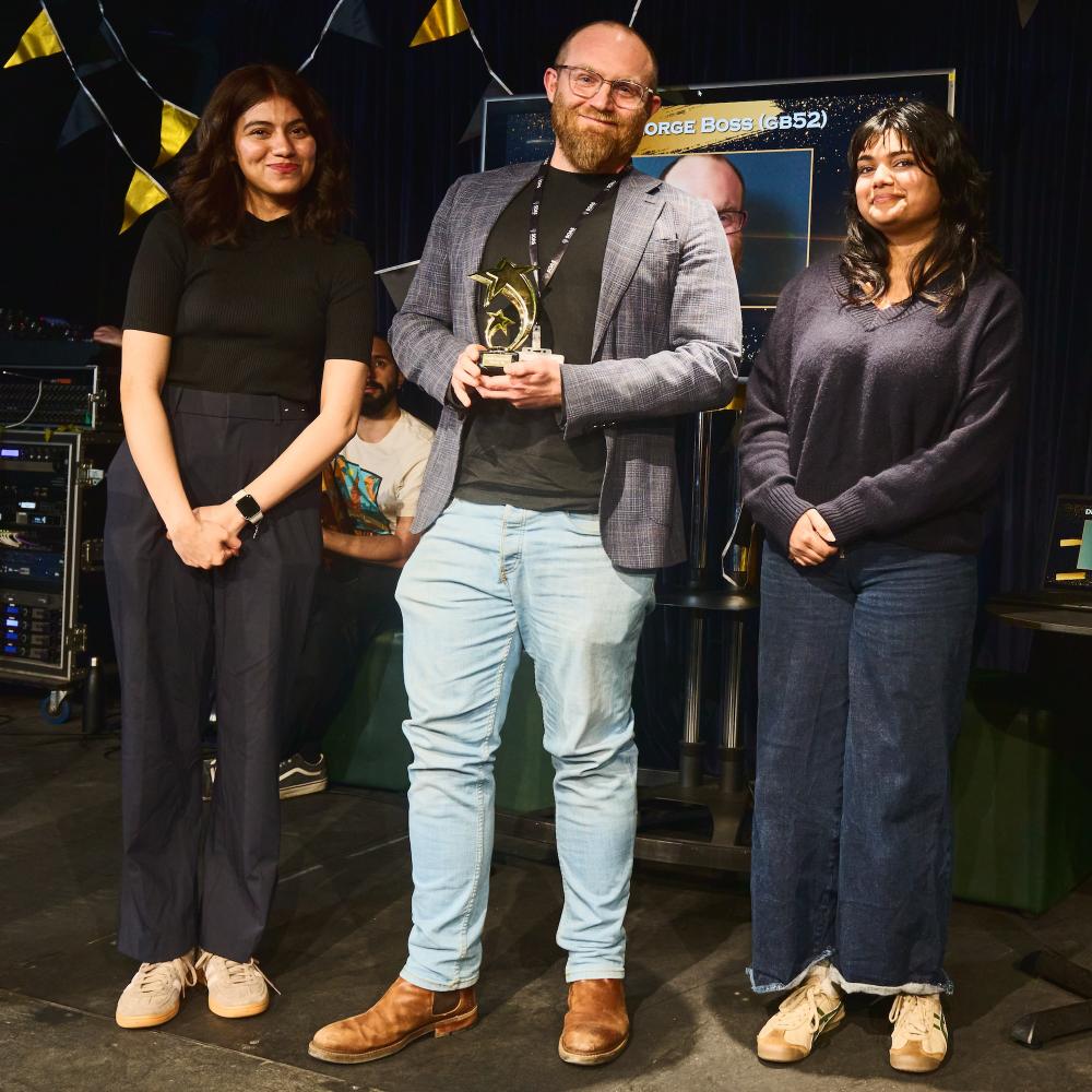 Dr George Boss holding award