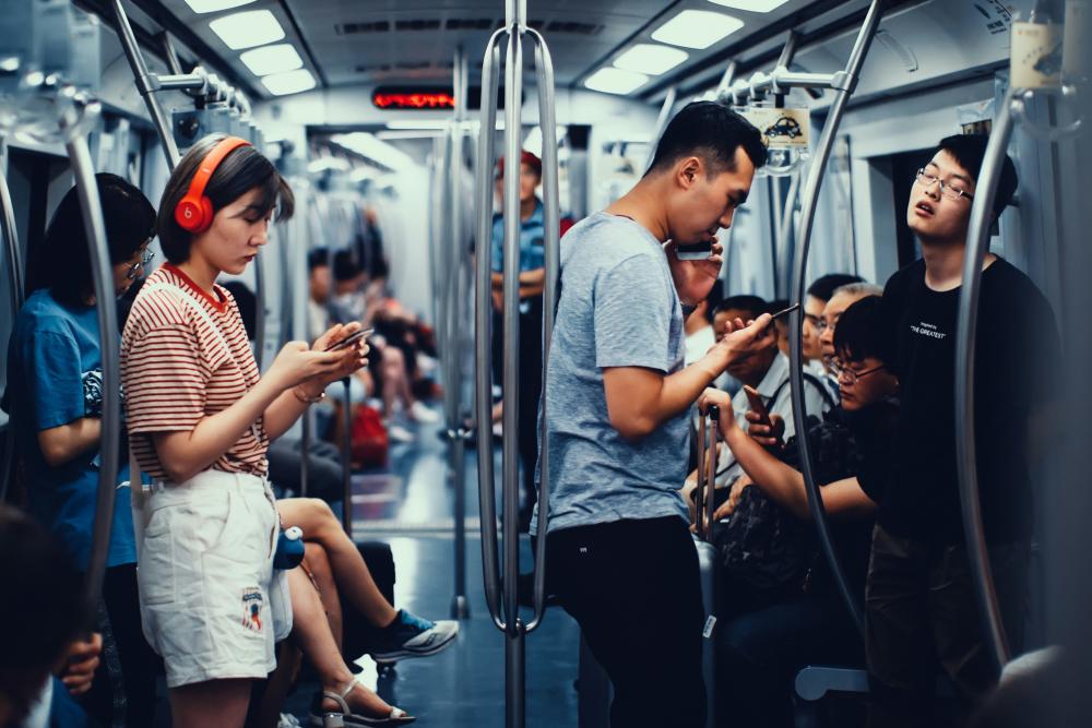 Subway carriage full of people on phones