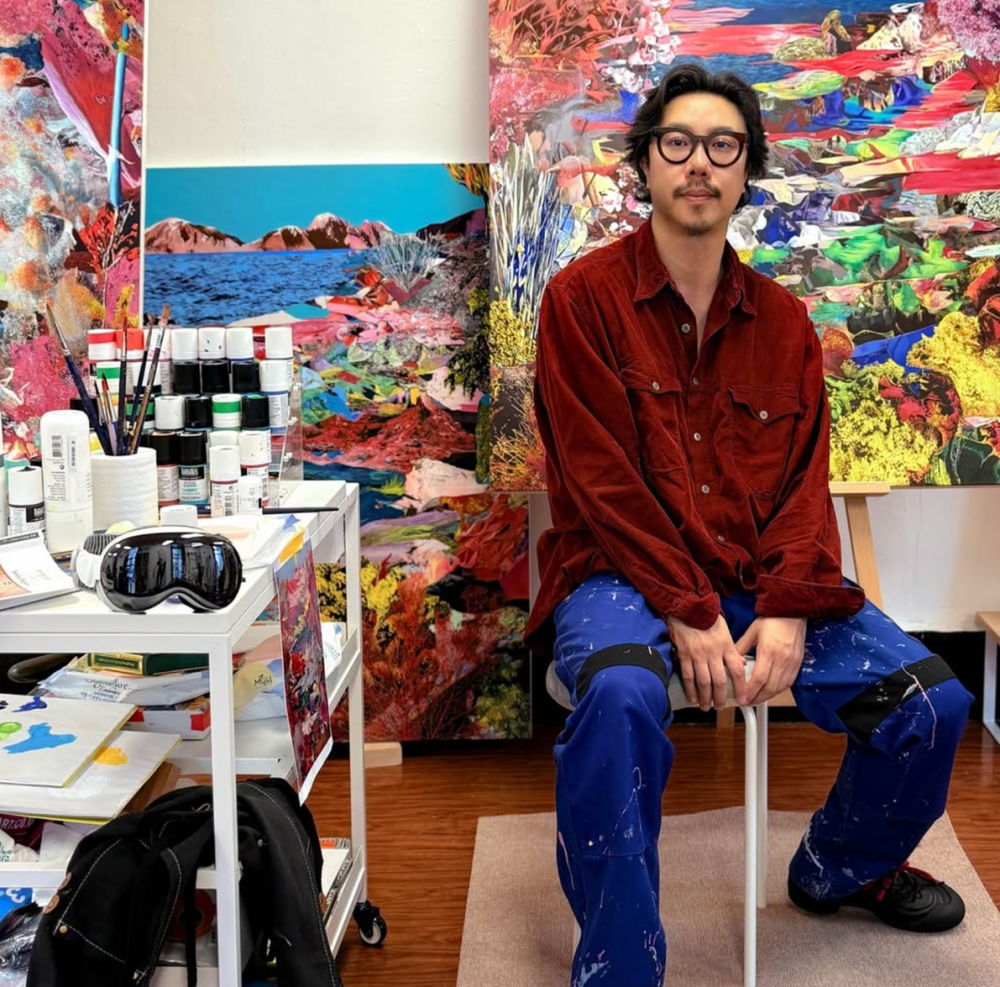 Man sitting in front of various artworks