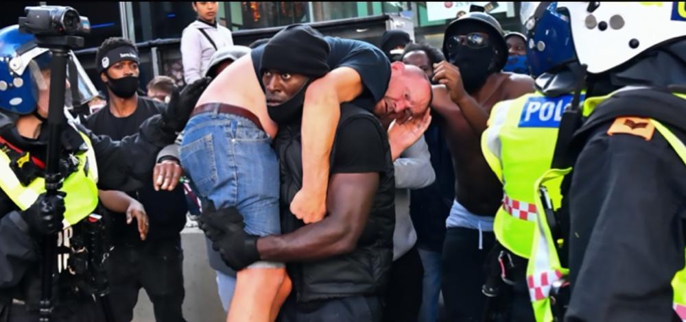 Patrick Hutchinson carrying a protestor at Black Lives Matter demonstration.