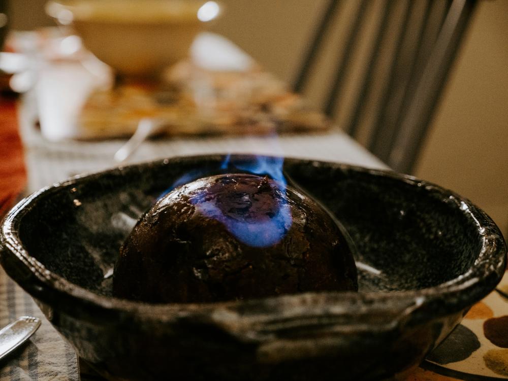 Christmas pudding on fire in a bowl.