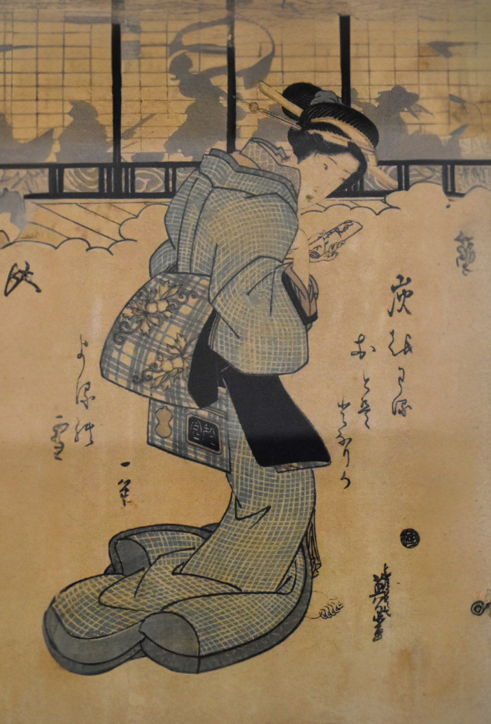 Japanese wood block illustration showing a woman holding a letter