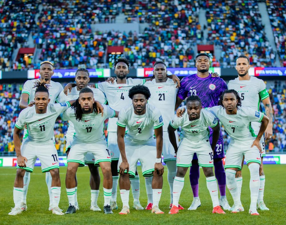 Nigeria's Super Eagles football team on the pitch with the audience behind