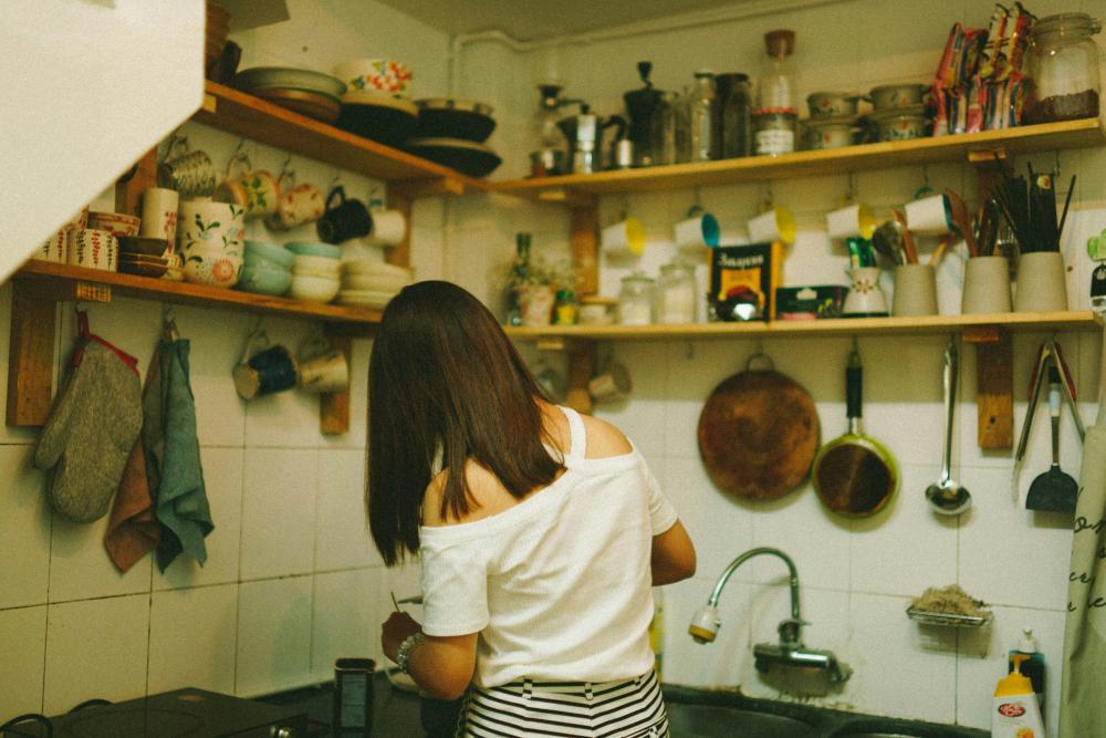 The back of a woman in the kitchen
