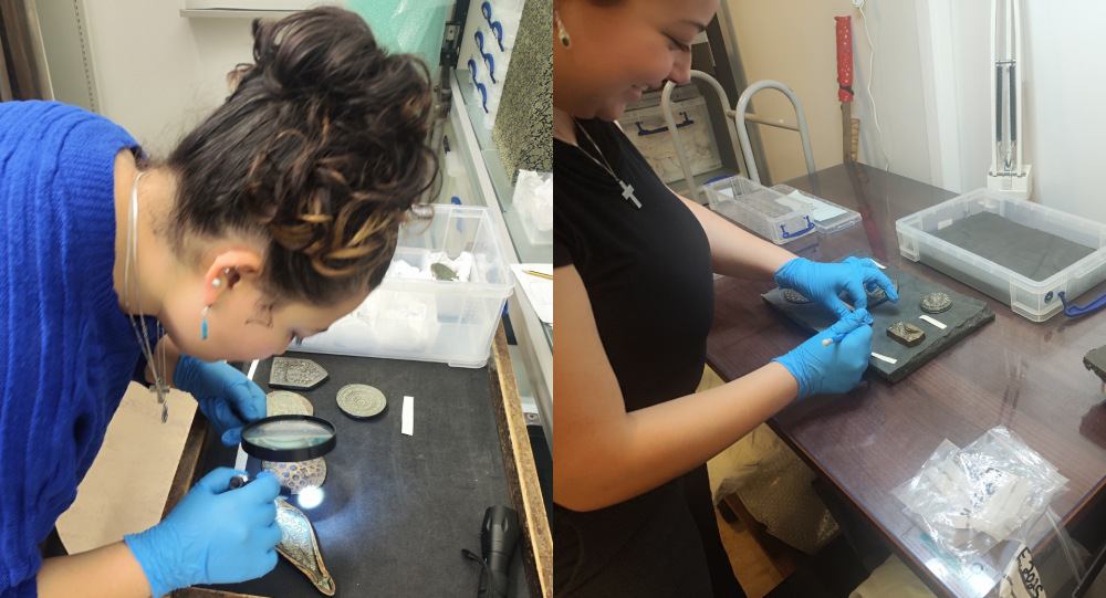 A student wearing blue gloves handles museum objects
