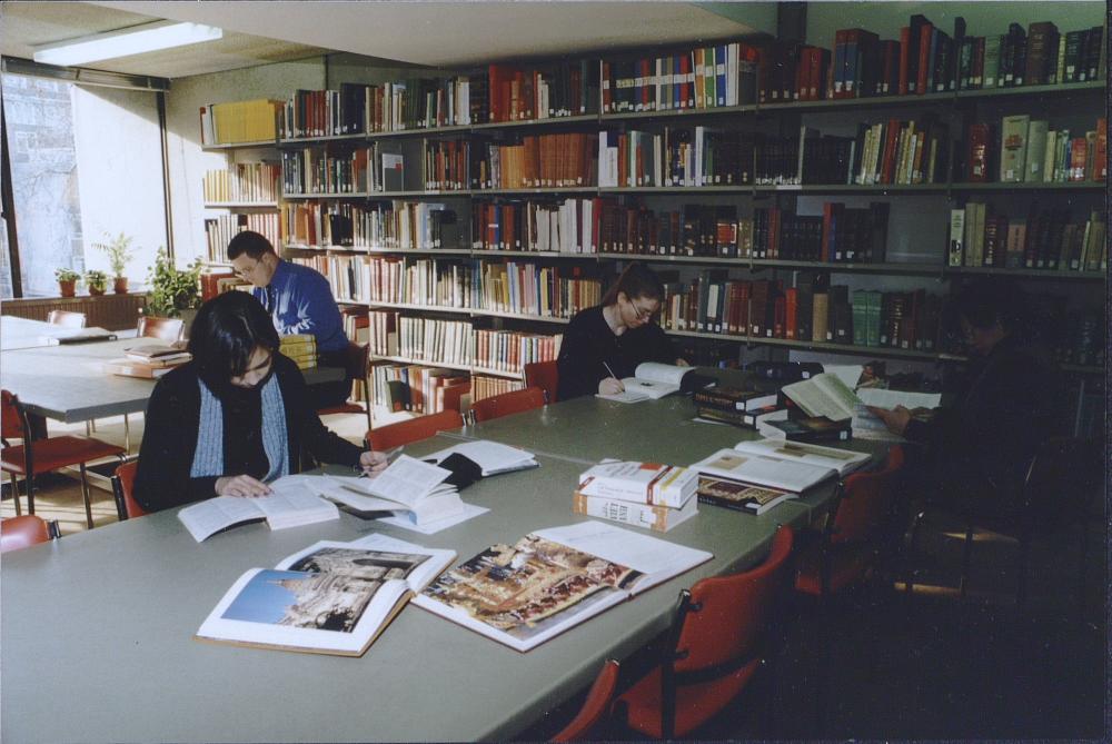 Group of people at desks in a library