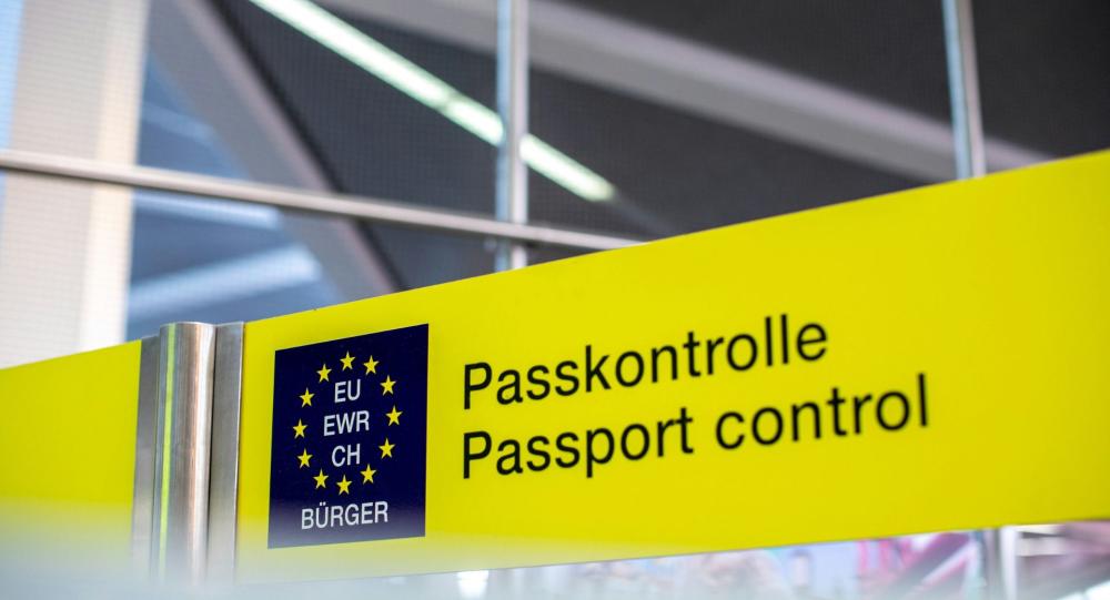 A yellow passport control sign
